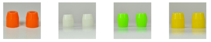 Skateboard bushings in orange, white and green