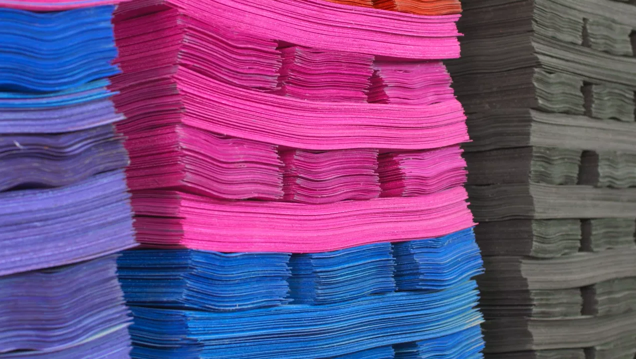 Stacks of pink, blue and natural maple veneers