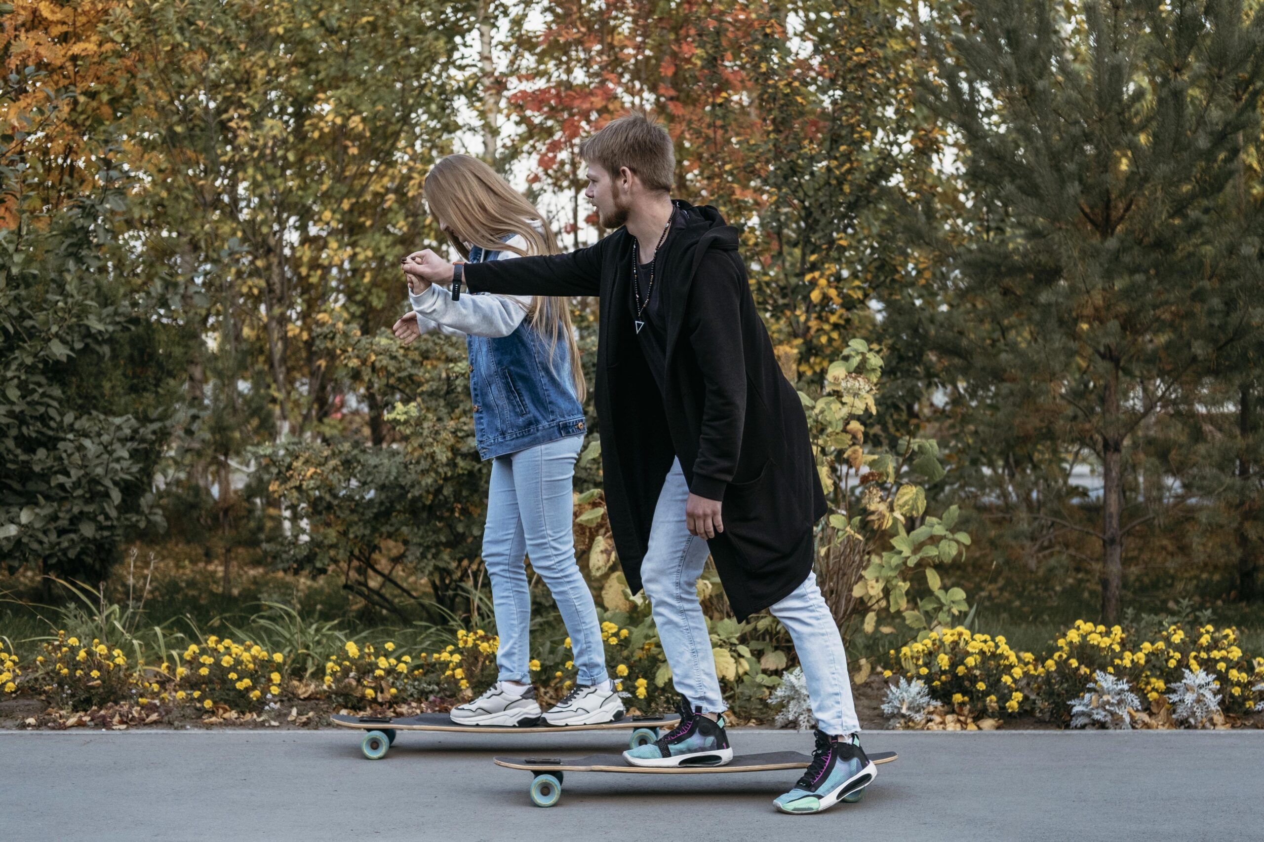Two people skateboarding together outdoors