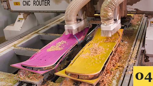 CNC router cutting pink and yellow skateboard decks